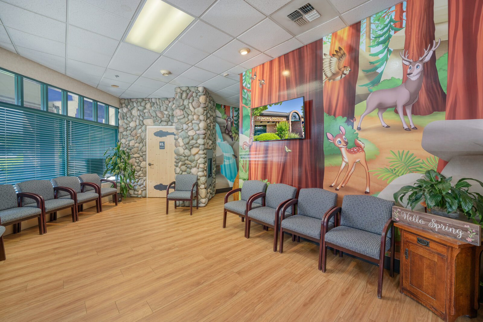 Lobby mural showing a forest stream and forest critters