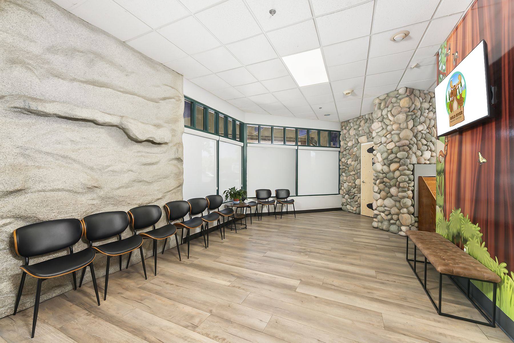 Waiting room chairs and leather bench beside the granite rock wall