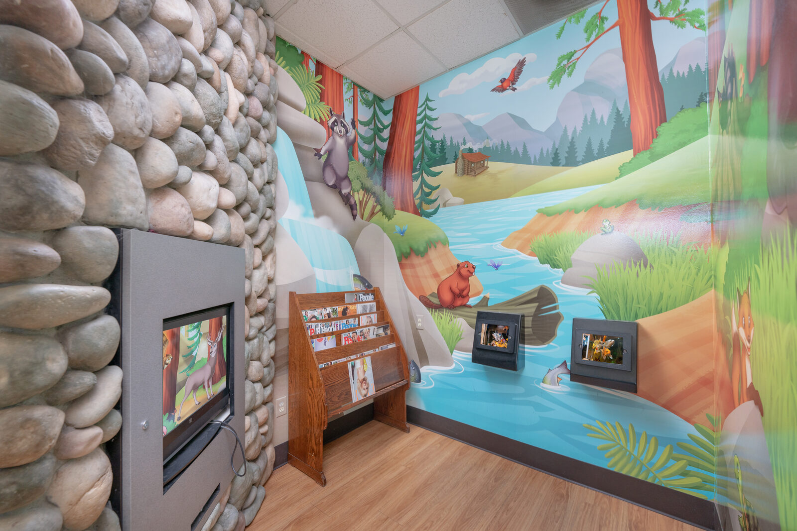 Forest mural with deer and a video game console for kids