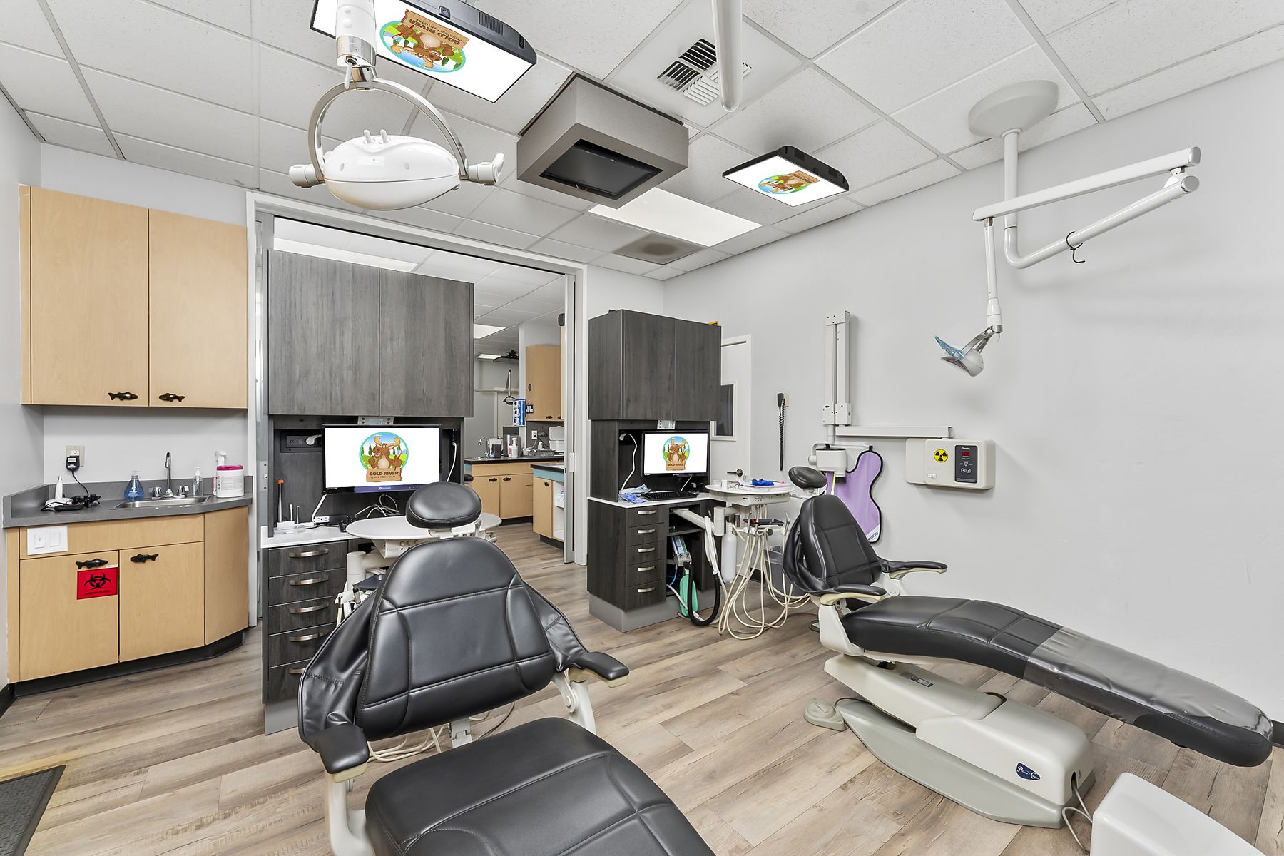 Two-chair treatment room with a TV mounted above each chair